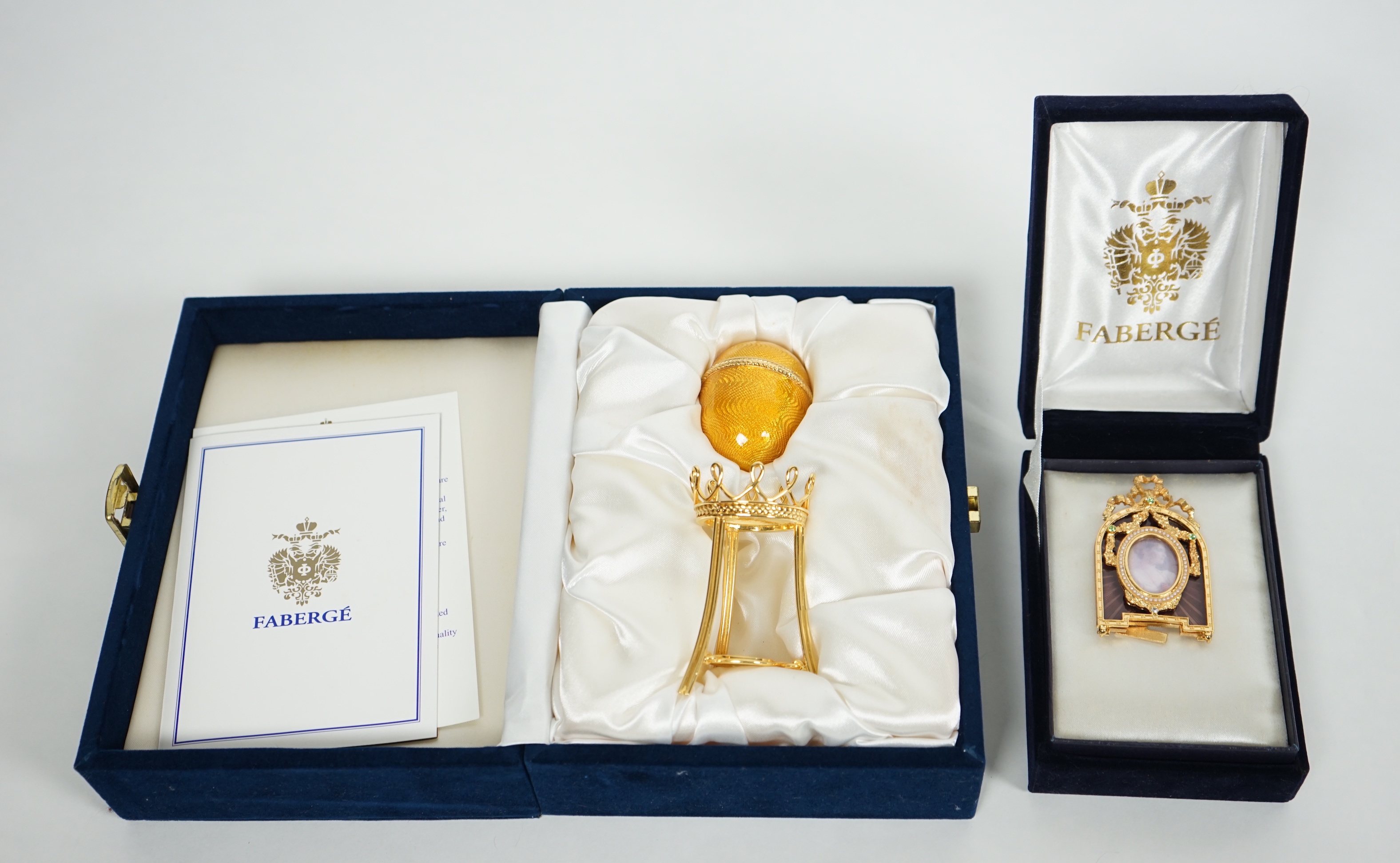A Fabergé Imperial Collection Menagerie Rabbit Surprise Egg on stand together with a Fabergé gilt and enamel photograph frame